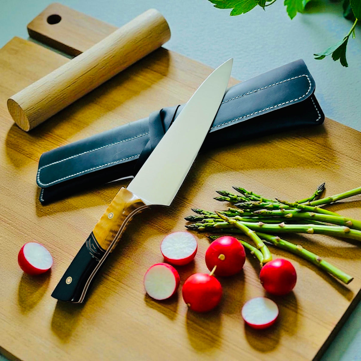 TANZO CUTLERY professional chef knife with a unique wooden handle, resting on a cutting board with fresh vegetables.